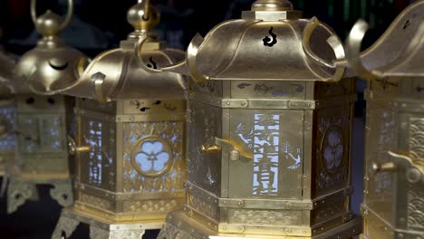 Close-Up-Detail-Shot-Of-Row-Of-Gold-Japanese-lanterns-at-Kasuga-taisha-Shrine