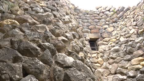 Inside-the-Nuraghe-Barumini-in-Sardinia,-Italy-Tilting-shot-on-this-ancient-and-mysterious-building