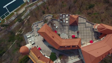 Drone-bird-eye-hover-flying-view-of-lake-Bled-castle-on-cliff