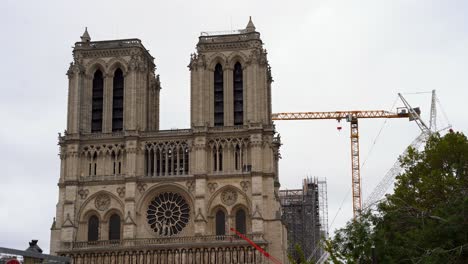Front-of-Notre-Dame-de-Paris-Cathedral-with-heavy-machinery-for-reconstruction-in-France