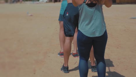 Athletes-carrying-wooden-bars-between-both-shoulders-and-throwing-back---Slow-Motion