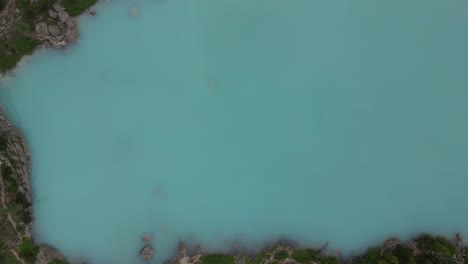 Turquoise-lake-Sorapis-filmed-top-shot-with-a-drone-in-the-Italian-alps,-Dolomites