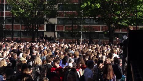 Young-festival-and-party-goers-enjoy-life-at-an-open-air-street-party-dancing-together-united-as-friends