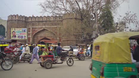 Old-Hyderabad-busy-city-street-and-crosswalk-of-people,-vehicles,-two-wheelers,-and-Rickshaws,-India