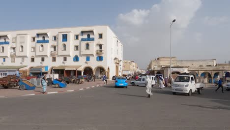 Lively-intersection-with-cars-and-pedestrians-passing