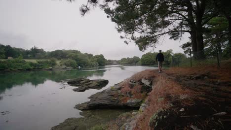 Adult-Male-Walking-Alongside-Riverbank-Of-La-Minaouet-River