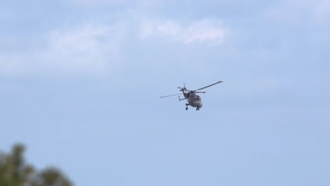 A-navy-lynx-helicopter-having-some-wind-turbulence-midair-in-Bournemouth,-England