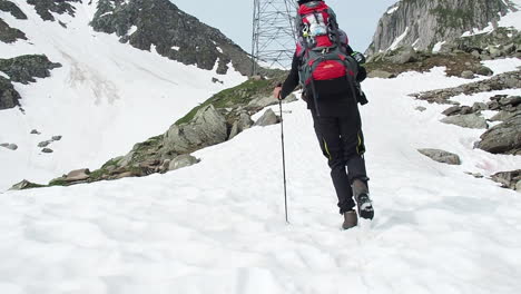 Slow-Motion-of-Solitary-Male-Mountaineer-With-Full-Equipment-Climbing-on-Hills-of-Swiss-Alps-Mountain-Range