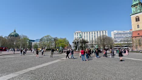 Tourists-Hanging-Around-The-Neptune-Fountain-In-Berlin-On-Sunny-Day-With-Clear-Blue-Skies