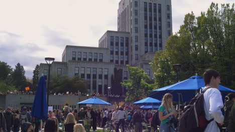 A-FORWARD-MOVING-DOLLY-Toward-Vancouver-City-Hall-as-a-Protestor-Walks-by-Holding-a-Game-of-Thrones-Style-Sign