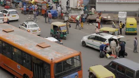 Motorbike-passing-traffic-on-busy-road,-Delhi-India