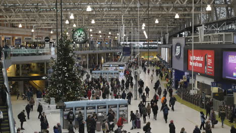 Wide-shot-of-a-busy-train-station-full-of-people-commuters-traveling-during-Christmas-season