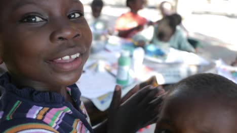 a-group-of-kids-with-disabilities-can-be-seen-drawing-outdoors-in-the-sunshine