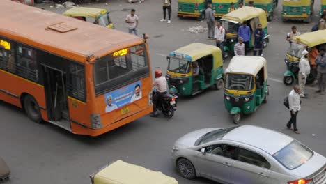 Motorbike-passing-traffic-on-busy-road,-Delhi-India