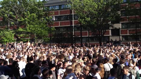 Young-festival-and-party-goers-enjoy-life-at-an-open-air-street-party-dancing-together-united-as-friends