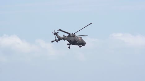 Tracking-zoomed-in-shot-of-a-Navy-Lynx-helicopter-in-super-slow-motion,-Bournemouth,-United-Kingdom