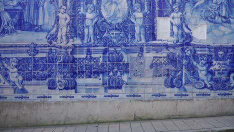 Full-Slow-motion-shot,-Women-walking-along-the-street-of-Porto,-Scenic-view-of-Capela-das-Almas-in-the-background