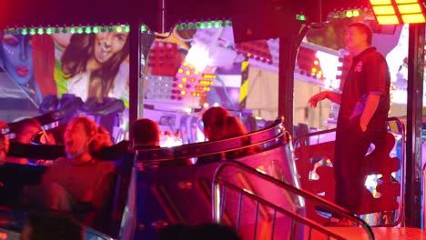 People-riding-and-spinning-in-high-speed-with-adrenaline-rush,-party-music-and-flashy-lights-at-Ekka-Royal-Queensland-Show,-Brisbane-Showgrounds,-handheld-motion-close-up-shot