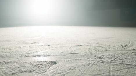 Slowmotion-of-group-of-people-slihouttes-ice-skating-on-a-snow-covered-winter-stadium