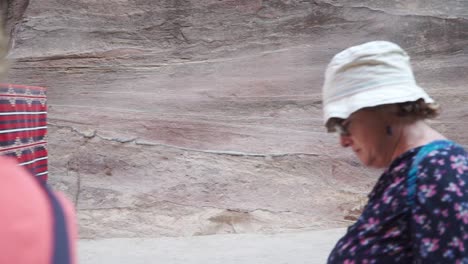 Horse-and-cart-and-tourists-walking-through-Petra-Jordan-wadi-ravine-canyon