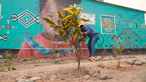 Circular-Shot-Of-Girl-Tilling-Land-Soil-For-Planting,-Medical-Clinic-Yard