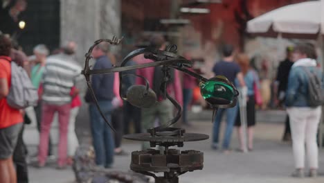 Spinning-Art-Installation-With-Defocused-VIsitors-In-The-Background-At-The-Black-Earth-Park-In-Nyoiseau