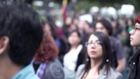 On-the-International-Women's-Day,-men-and-women-are-marching-together-as-they-hold-signs-and-wave-flags-in-protest