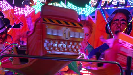 Vibrant-80s-neon-lights,-people-riding-and-spinning-in-high-speed-with-adrenaline-rush-at-Ekka-Royal-Queensland-Show,-Brisbane-Showgrounds,-handheld-motion-close-up-shot