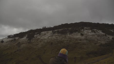 Young-male-photographer-capturing-photos-of-sno-covered-mountains