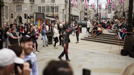 A-older-person-dancing-with-a-rose-to-buskers-music