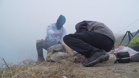 Camper-Warming-His-Hands-With-Bonfire-In-Cold-Weather,-Obrajillo,-Lima,-Peru