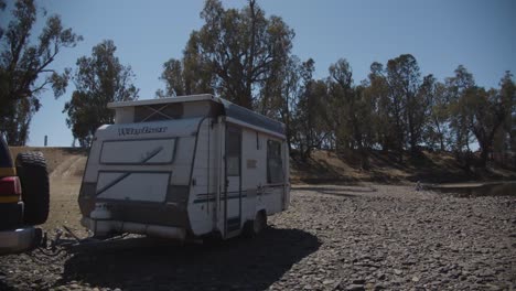 Yellow-car-with-caravan-camping-at-Ponto-Falls-Reserve