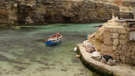 Tied-Up-Colourful-Boat-In-Shallow-Sea-In-The-Anchor-Bay