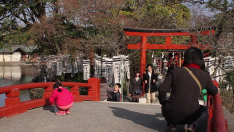 Young-child-on-red-bridge-with-parent-in-Japan