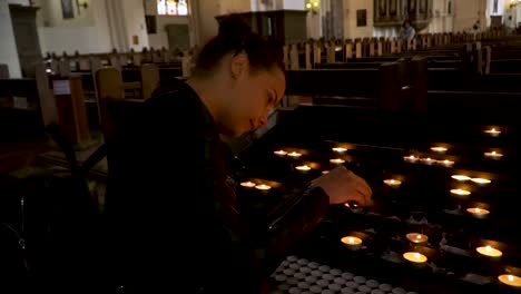 Mujer-Encendiendo-Velas-En-La-Iglesia.