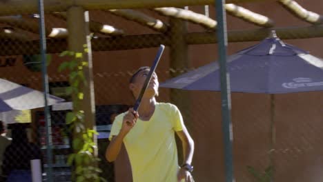 A-young-player-jumps-up-to-hit-a-ball-during-a-game-of-beach-tennis