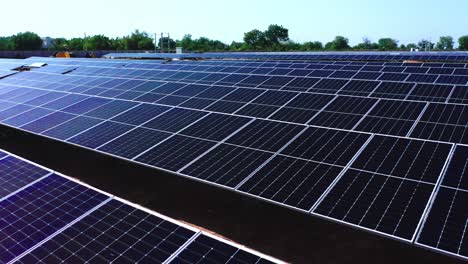 close-up-view-from-the-aerial-drone-camera-shows-several-solar-modules-with-panels