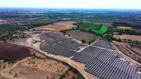 La-Cámara-Aérea-De-Un-Dron-Avanza-Donde-Los-Paneles-Solares-Generan-Energía-Verde-Y-La-Entregan-A-Una-Central-Eléctrica-Cercana.