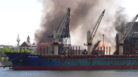 Flames-and-smoke-of-the-burning-Domino-Sugar-plant-as-seen-from-across-the-harbor