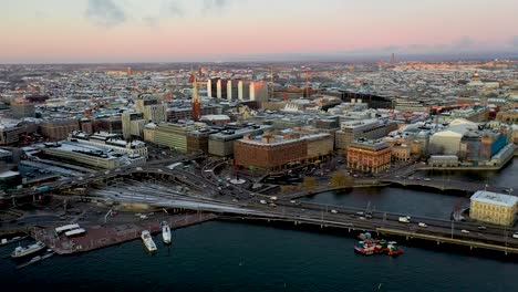 Panning-drone-footage-of-Stockholm,-Sweden-at-sunset