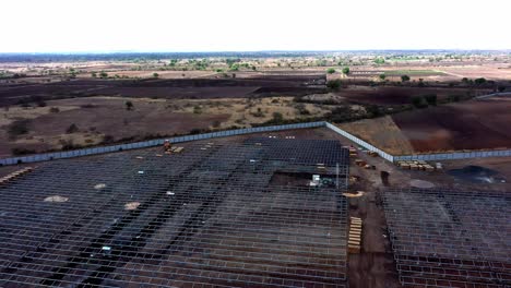 Aerial-rotted-shot-of-labor-picking-up-solar-modules-for-the-installation-at-a-solar-power-plant