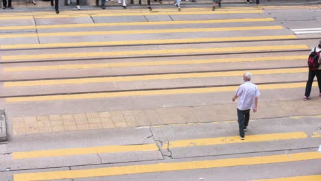 Pedestrians-walk-through-a-busy-and-crowded-zebra-crossing-junction