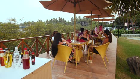 A-group-of-friends-sitting-and-talking-to-each-other-at-a-restaurant-in-Goa