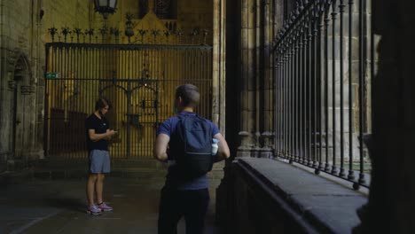 Young-man-with-mask-in-inner-church-courtyard-of-Barcelona-Cathedral-sightseeing