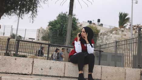 Muslim-Woman-Wearing-Hijab-using-a-cell-phone-smartphone-Culture-Female-authentic-Middle-East-Israel