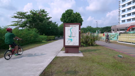 Cyclists-cycling-in-slow-motion-at-Punggol-Promenade-Park,-Singapore