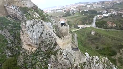 Drone-shot-over-the-Chiaramonte-castle-in-Mussomeli,-the-town-in-Sicily-where-houses-are-sold-at-1-Euro