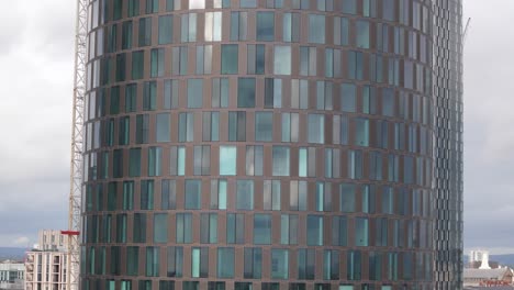 Manchester-Deansgate-close-up-aerial-view-flying-across-contemporary-geometric-glass-business-district-skyscrapers