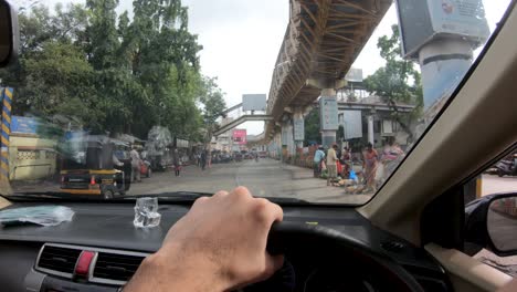 Driving-Through-The-Urban-Road-With-Some-Local-Indians-Walking-And-Buying-Goods-At-The-Sidewalks-During-Pandemic-In-Mumbai,-India---POV-Shot