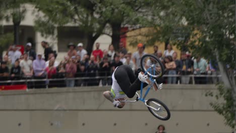 At-the-skate-park,-the-young-man-confidently-executes-gravity-defying-tricks-on-his-bicycle-at-impressive-heights,-successfully-landing-each-one-with-precision-and-skill